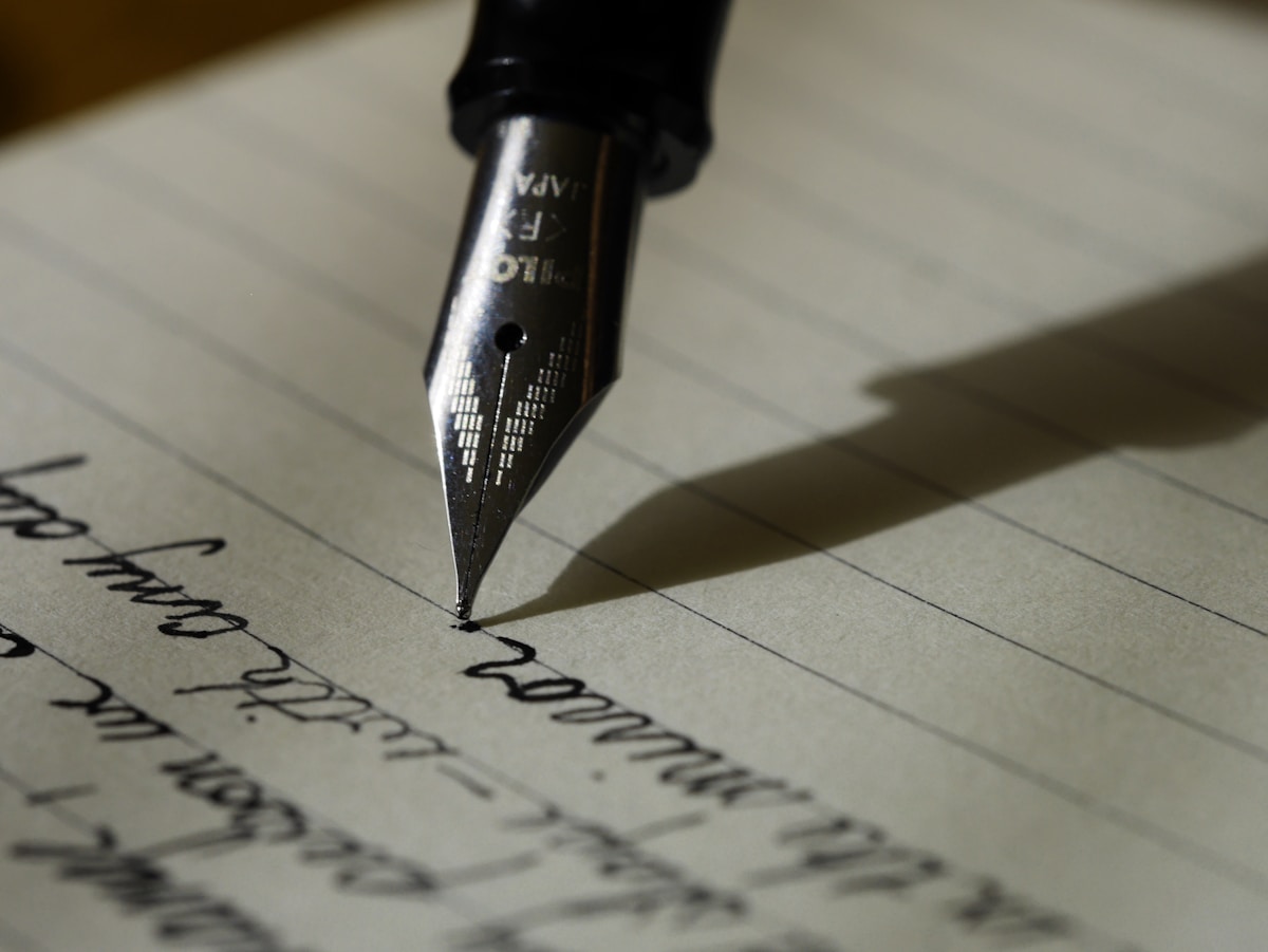 Fountain pen writing on handwritten lined paper, representing the high-conflict co-parenting blog playbooks