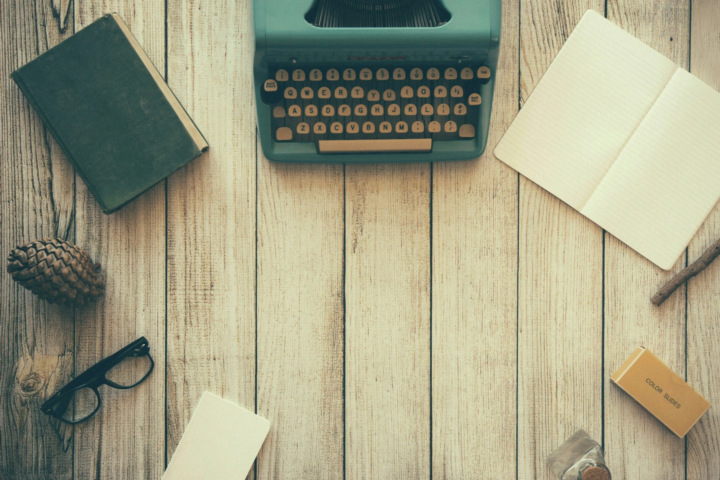 Co-parenting message ghostwriting workspace with vintage typewriter and notebook
