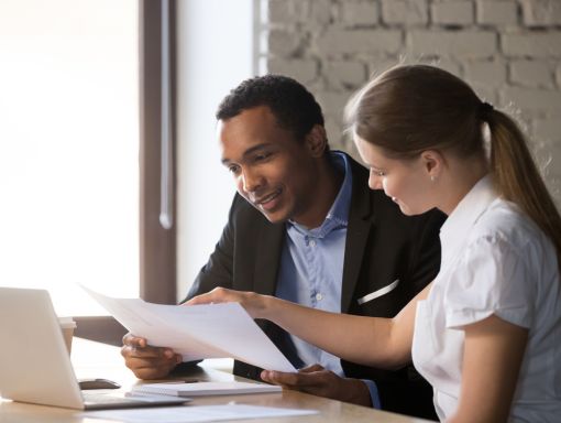 Coach and client reviewing court documents together at a desk, preparing strategy for a custody hearing or mediation